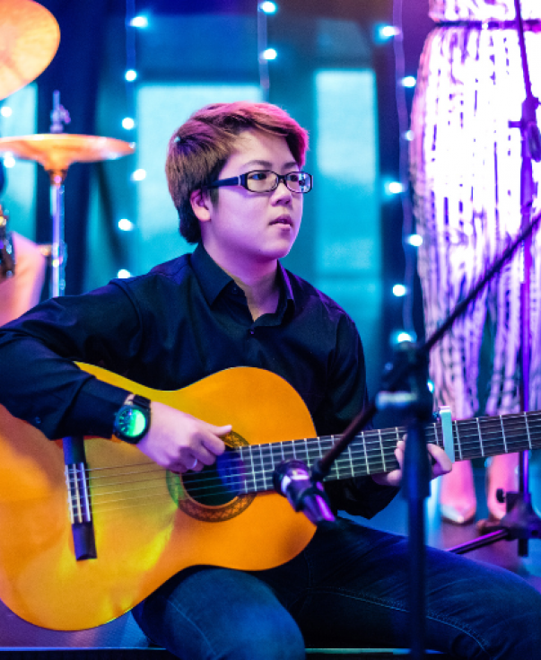 Student playing guitar